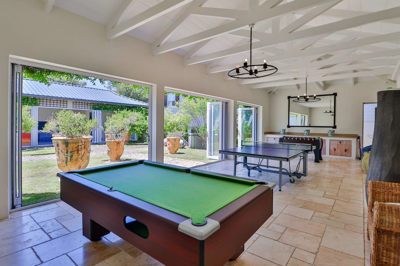 Alternate view of foosball table, table tennis and pool table in games room for games night at home