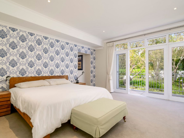 Alternate view of wooden bedside table in neutral bedroom