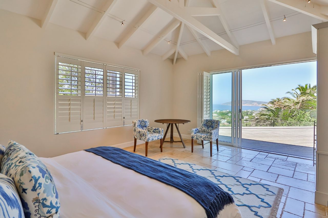 Bedroom with white and blue theme and natural light shining in