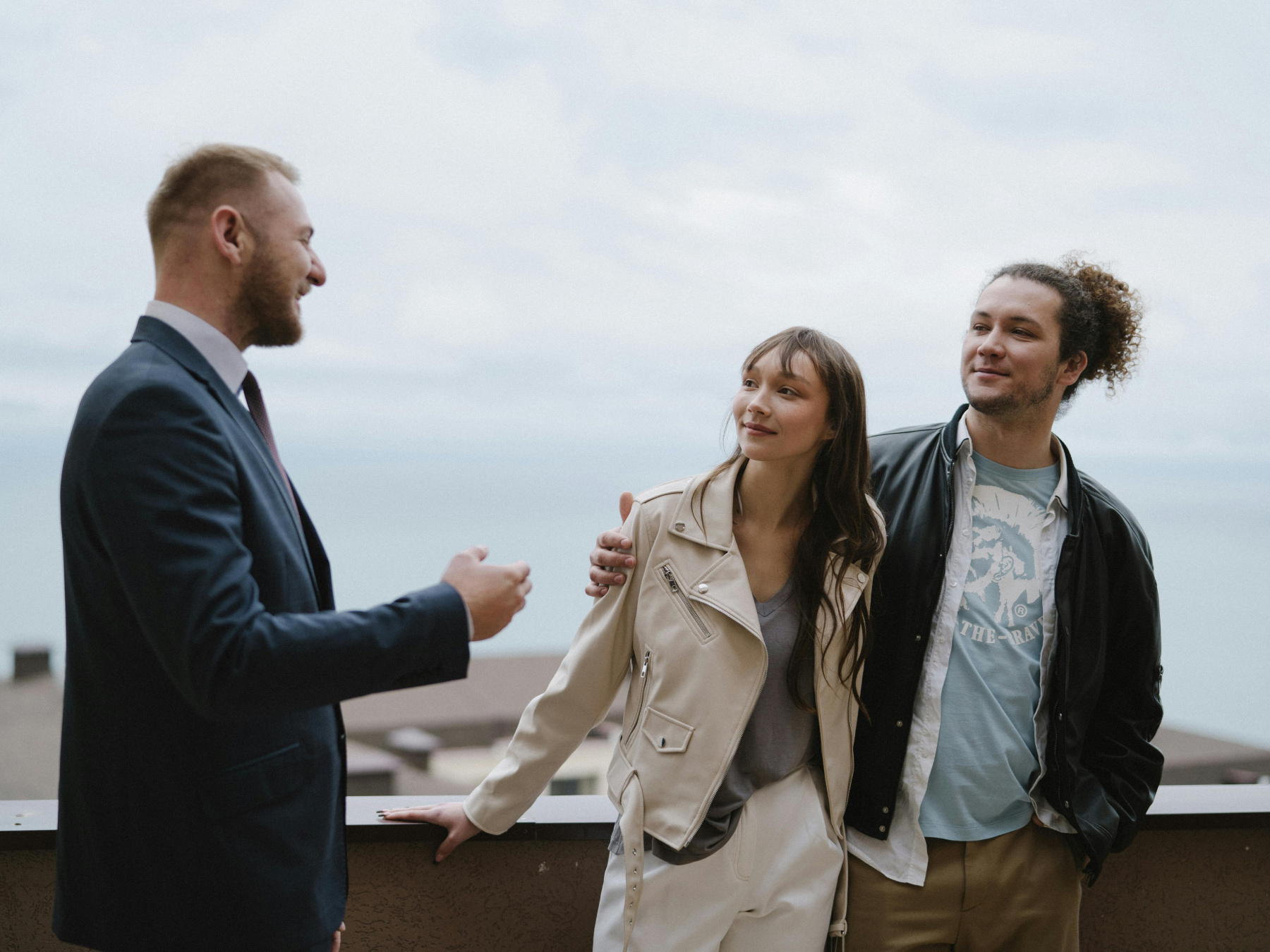 Real estate agent guides young couple buying a home