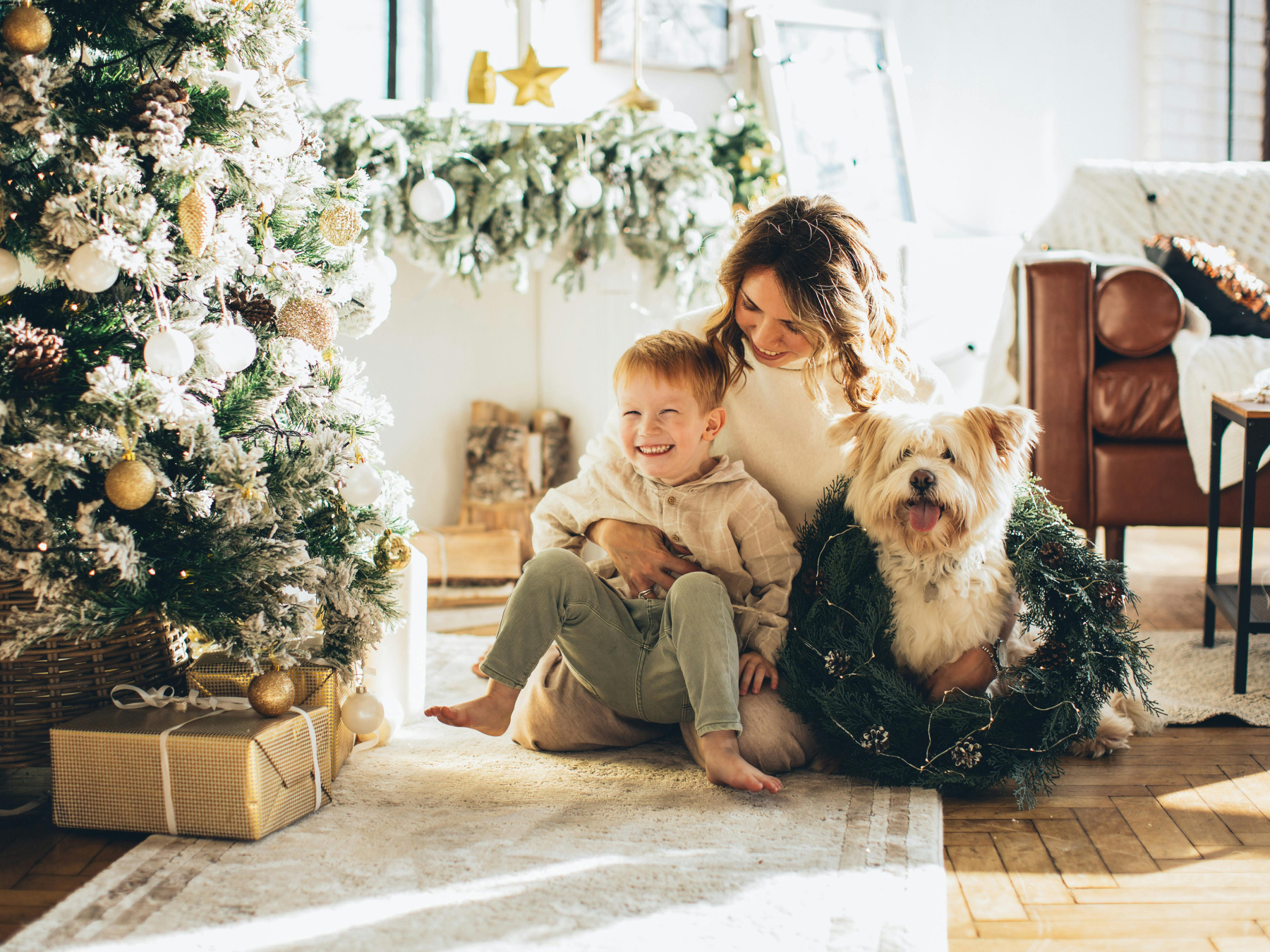 A mum, son, and dog enjoy their home's Christmas decor