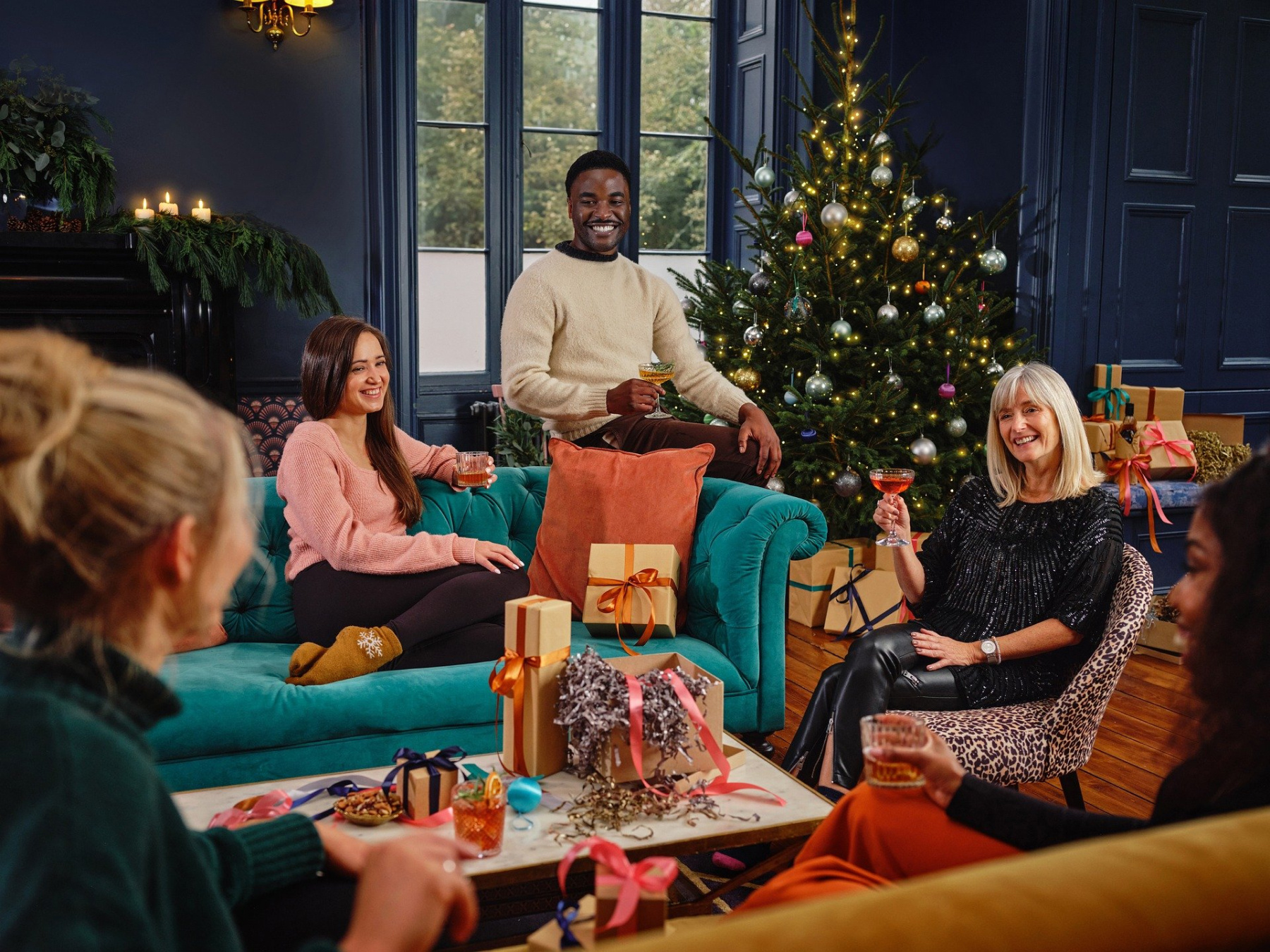 A group of people unwrap presents during Christmas