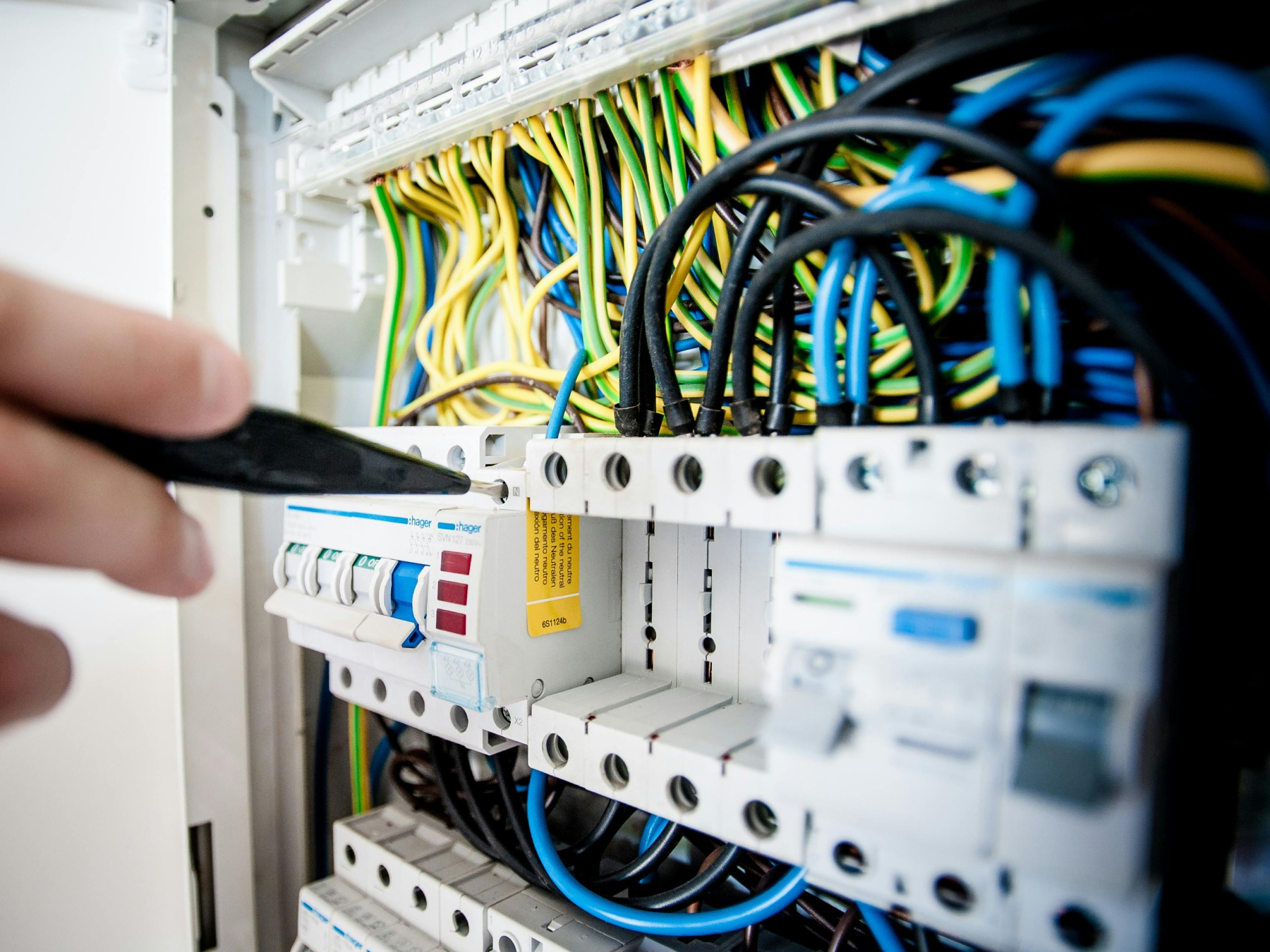 Technician performs maintenance on an electrical system