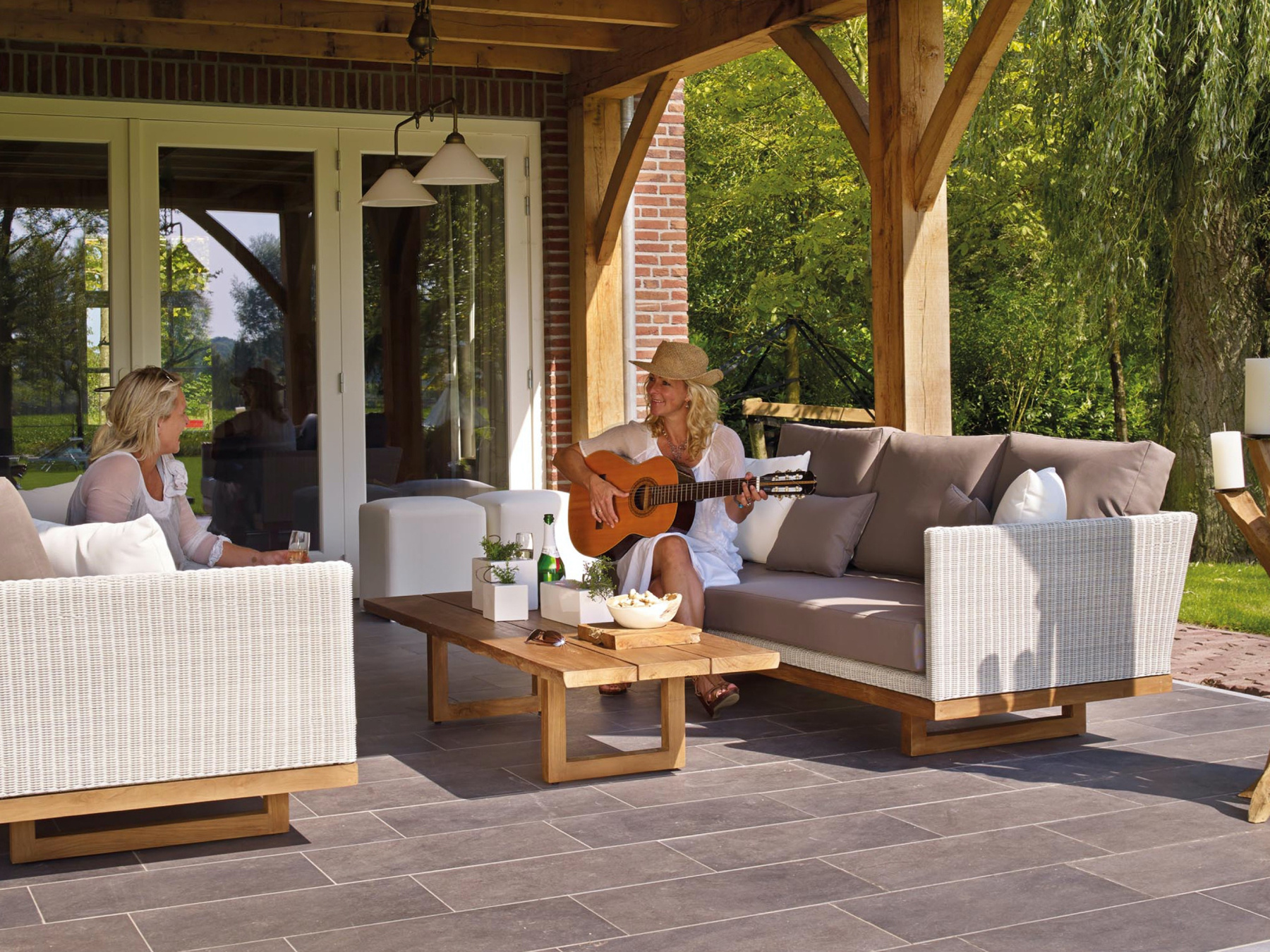 Two women enjoying the outdoor living space or patio area