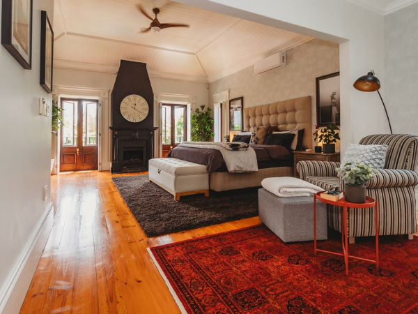 Striped armchair in bedroom with rugs