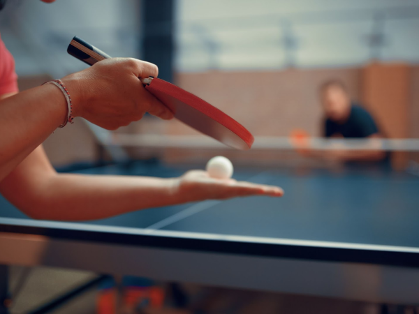 Two people playing table tennis together