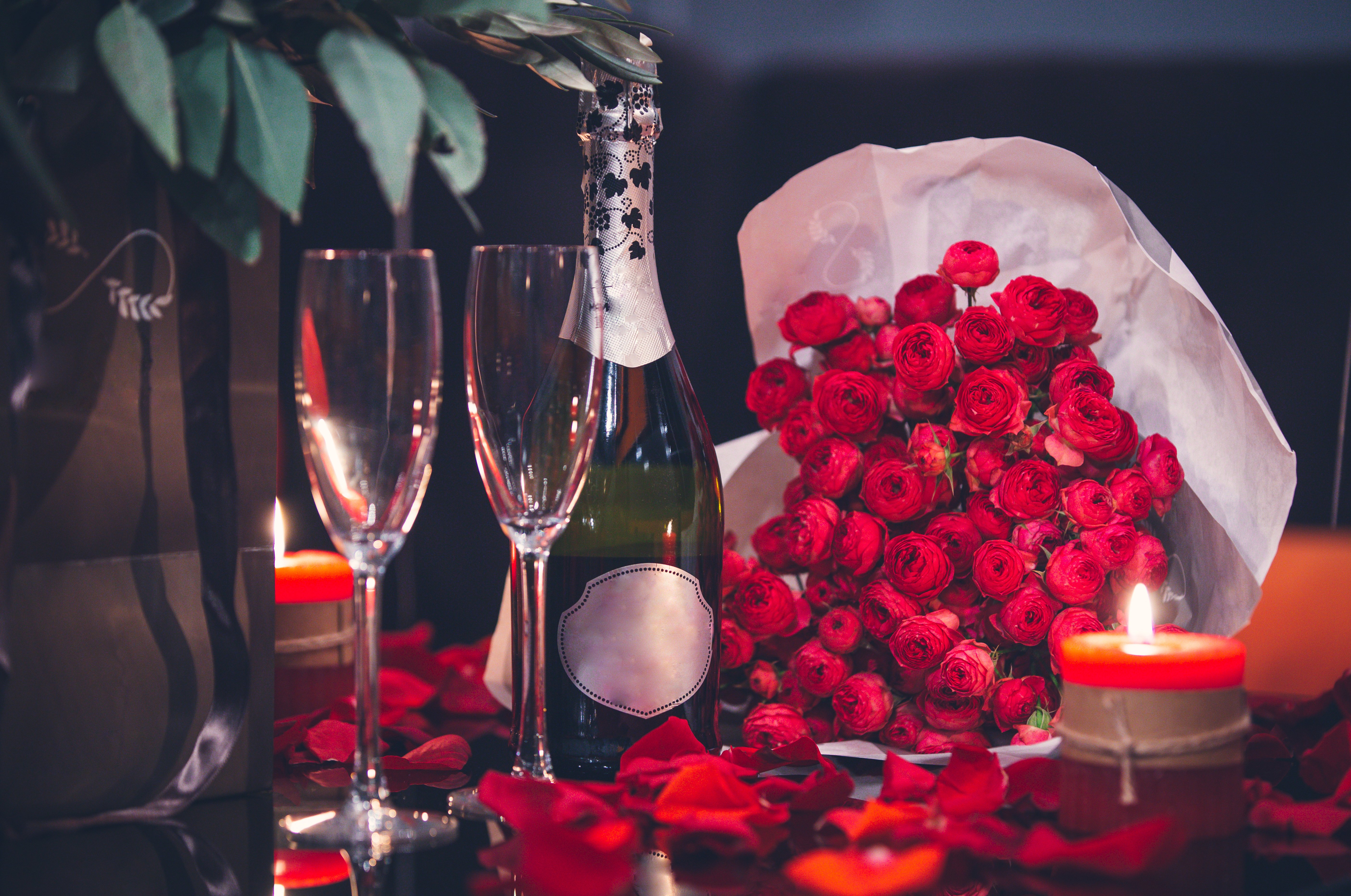 red-roses-two-glasses-bottle-champagne-candle-table